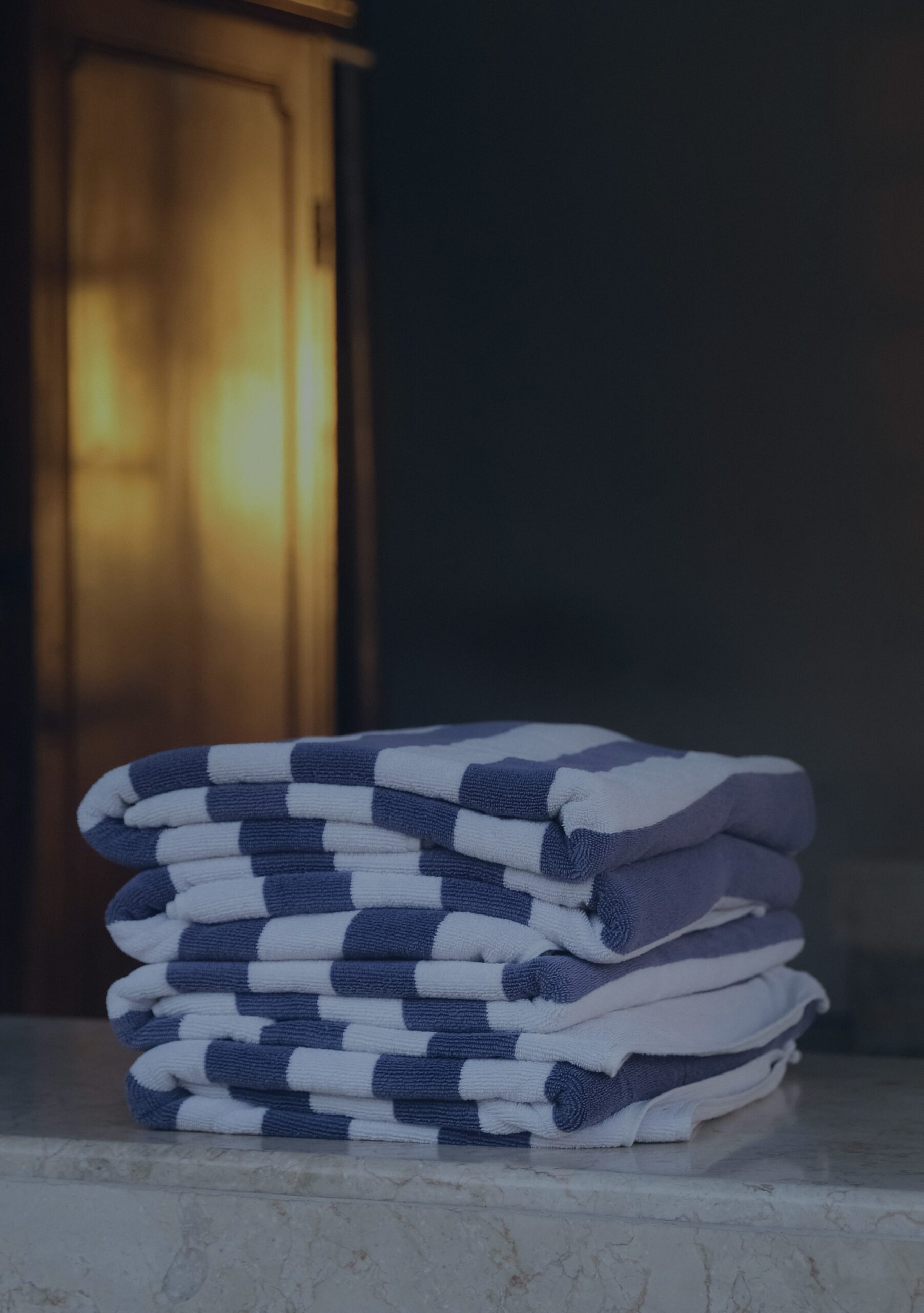 A stack of folded towels sitting on top of a counter