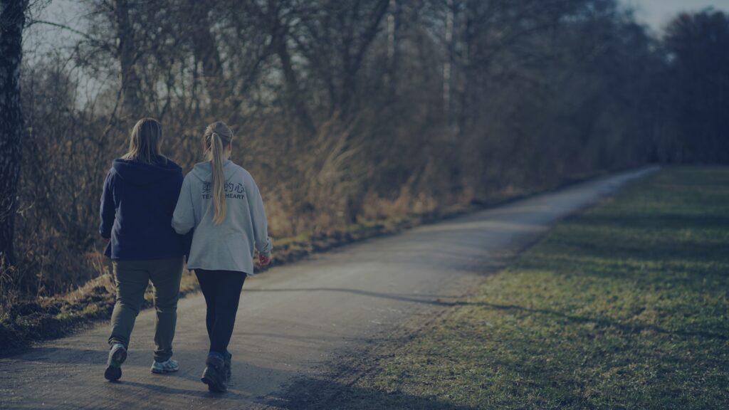 Two adults friends walking and in deep conversation