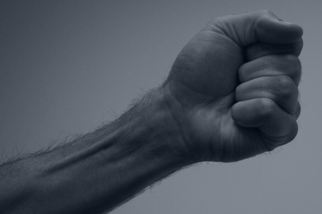 Close-up of tightly clenched hands, a physical sign of nervous system tension