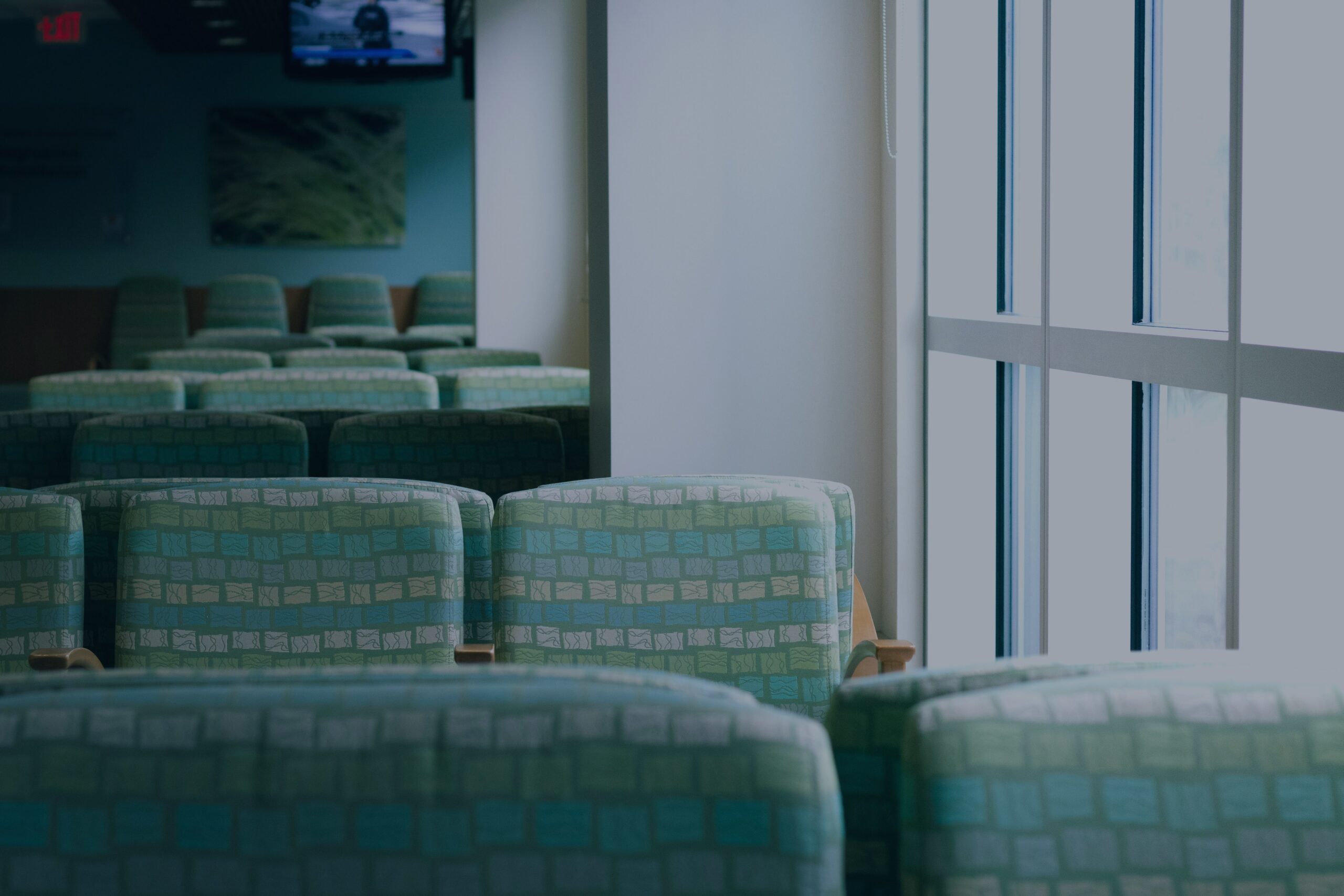 Empty chairs line a quiet hospital waiting room, capturing the disorienting limbo of becoming a caregiver for a spouse overnight.